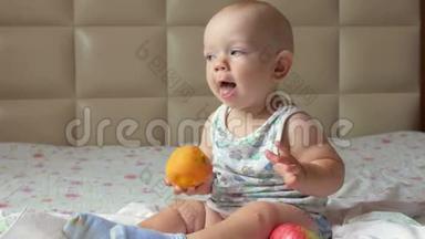 一个漂亮的婴儿在床上早餐吃桃子。他撕下一块放进嘴里